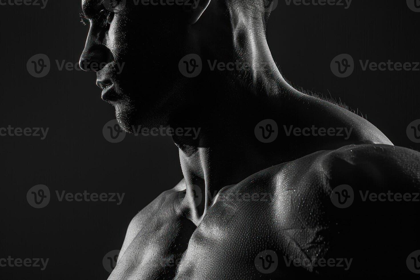 A man with a muscular body is posing in black and white photo
