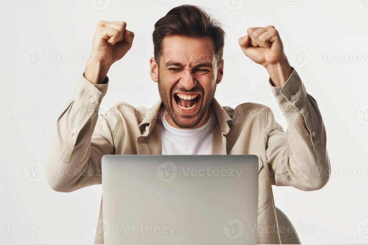A man is excited while using a laptop photo