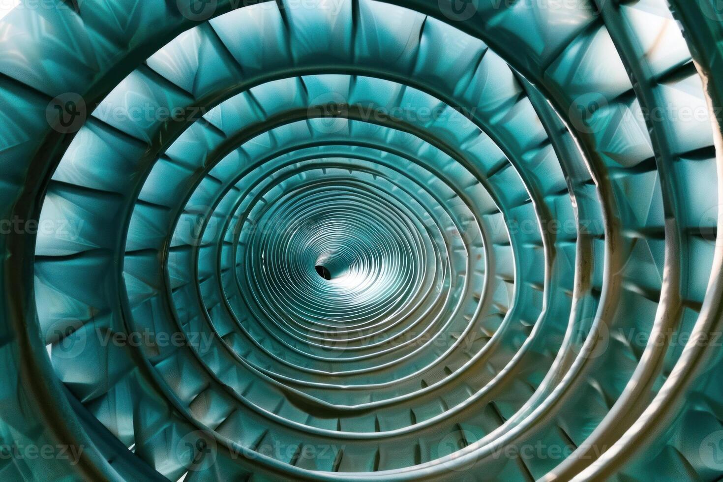 A blue spiral tunnel with a circular shape photo