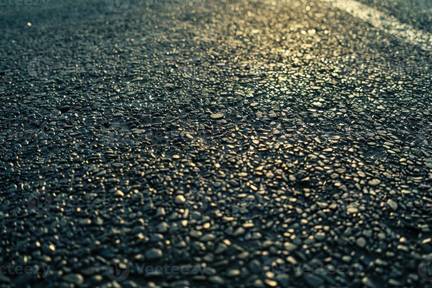 An asphalt road with a sun shining in the background photo