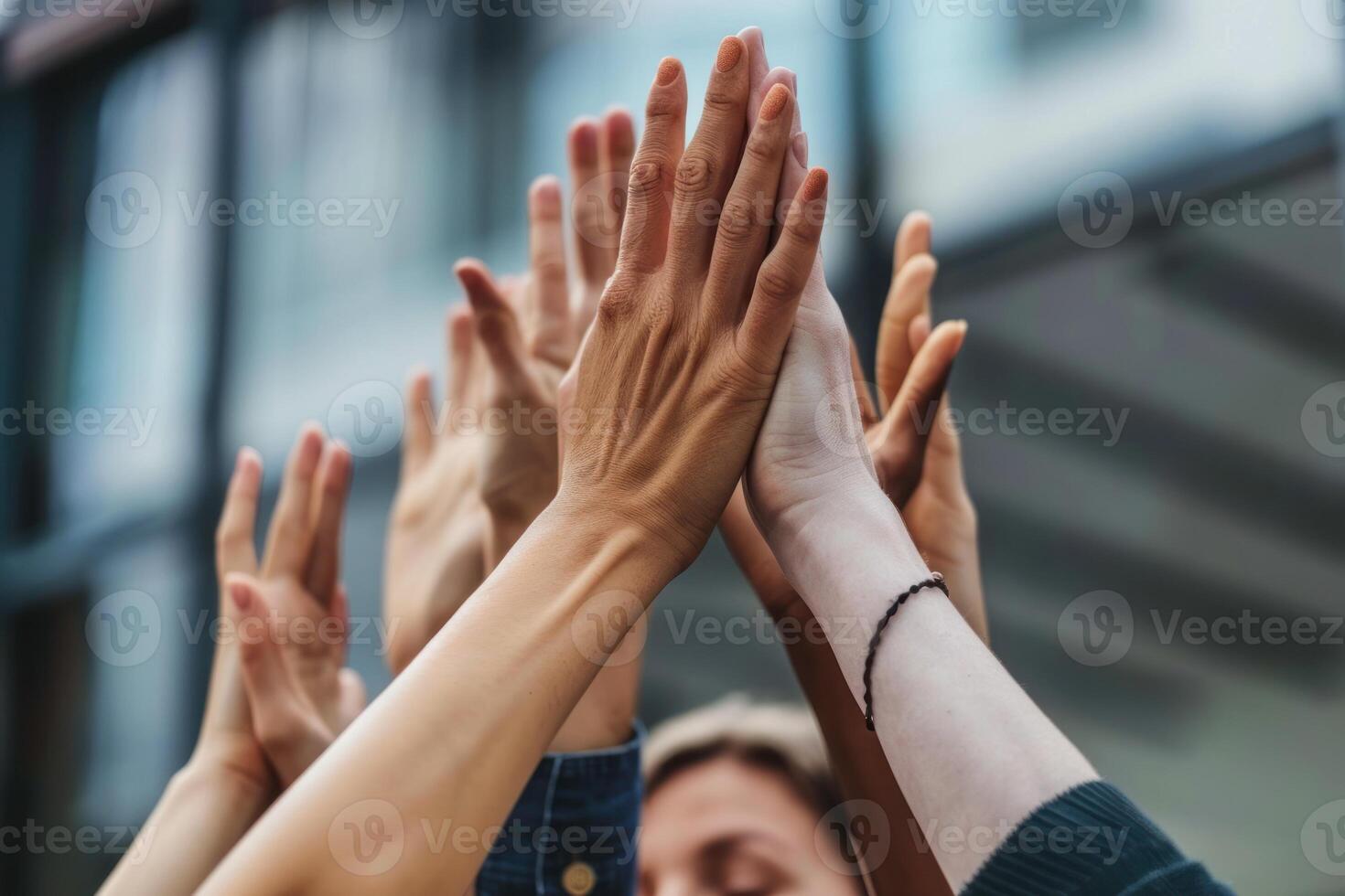 Group of people with their hands up in the air photo