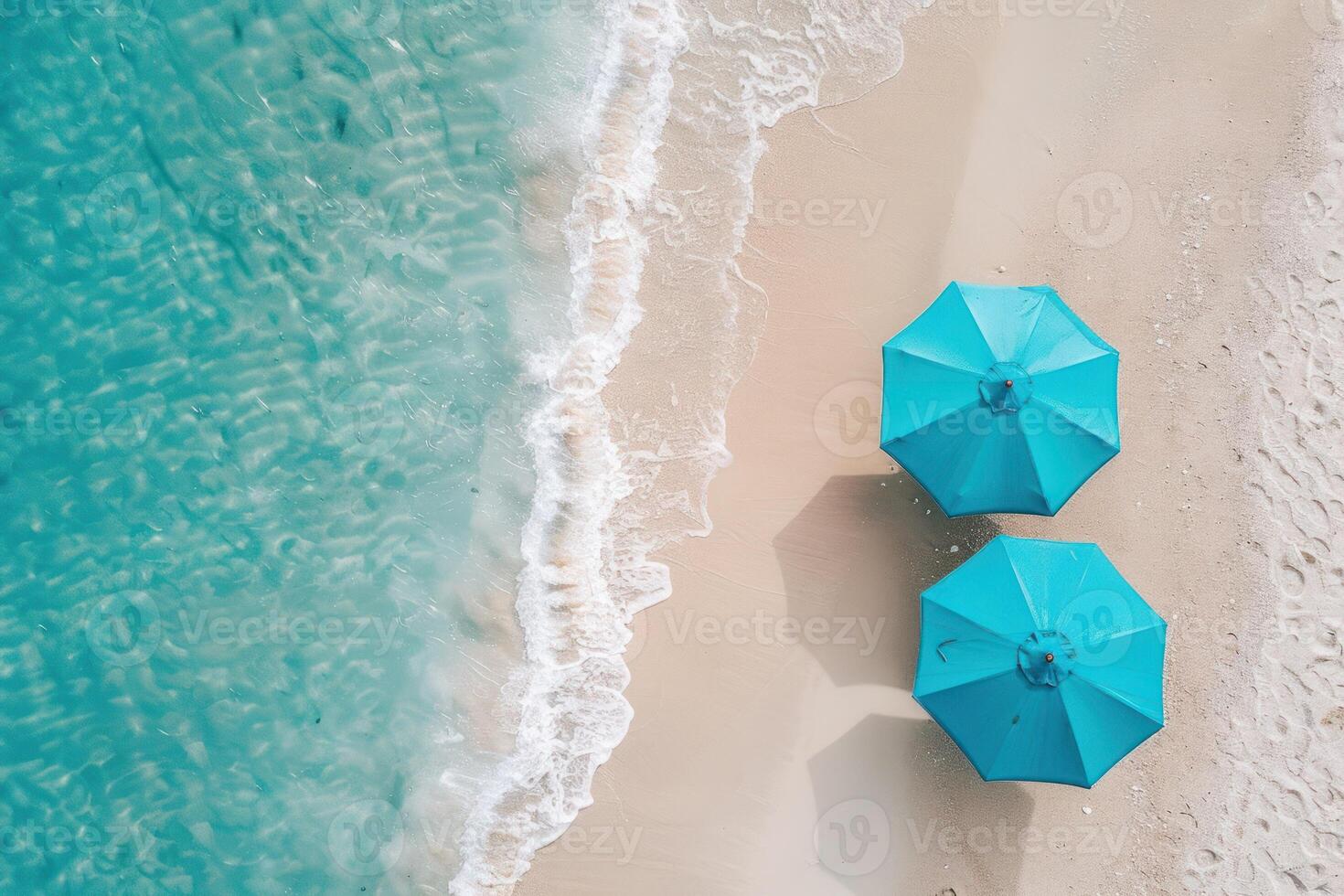 Two blue umbrellas on a sandy beach photo
