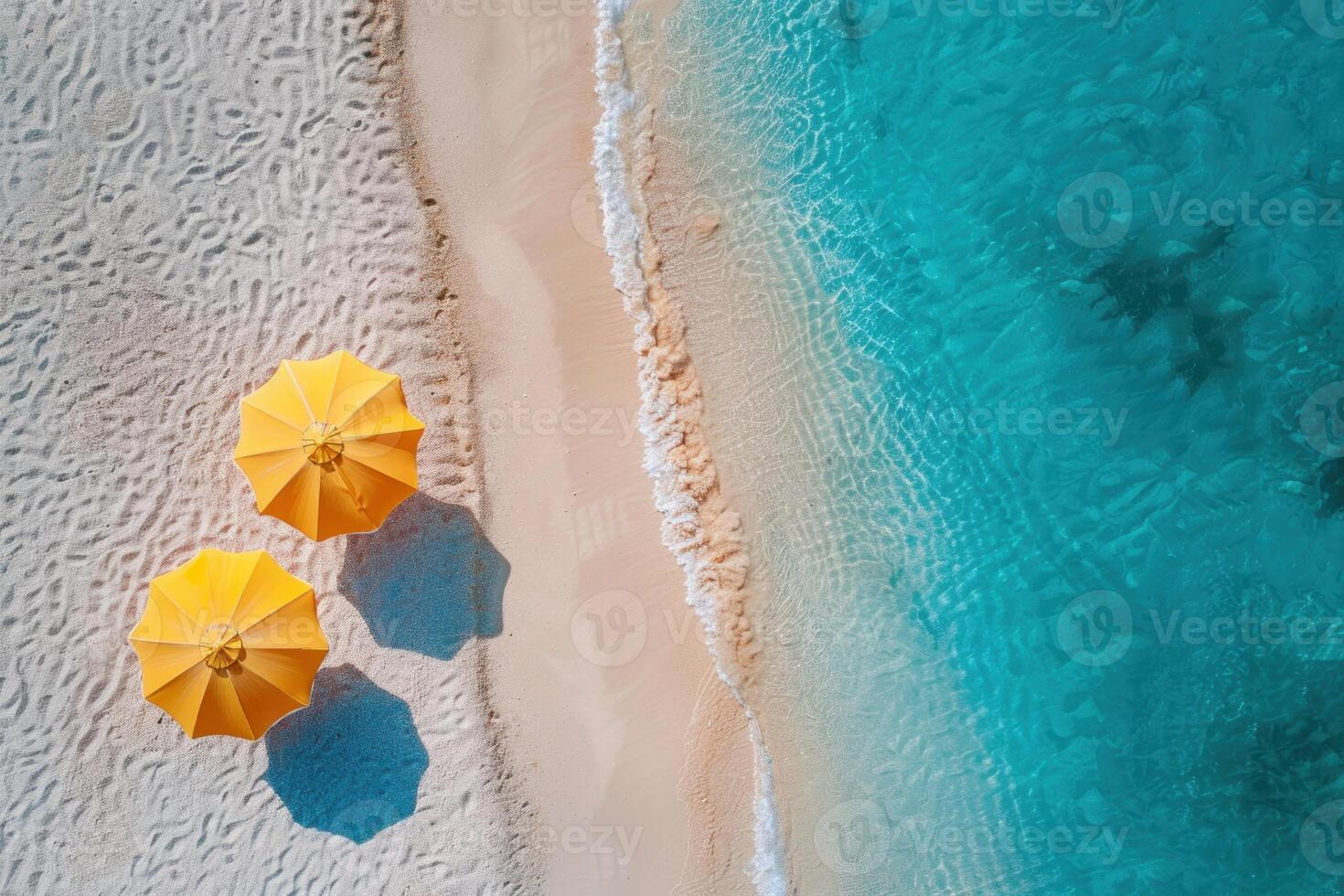 Two yellow umbrellas on a sandy beach photo