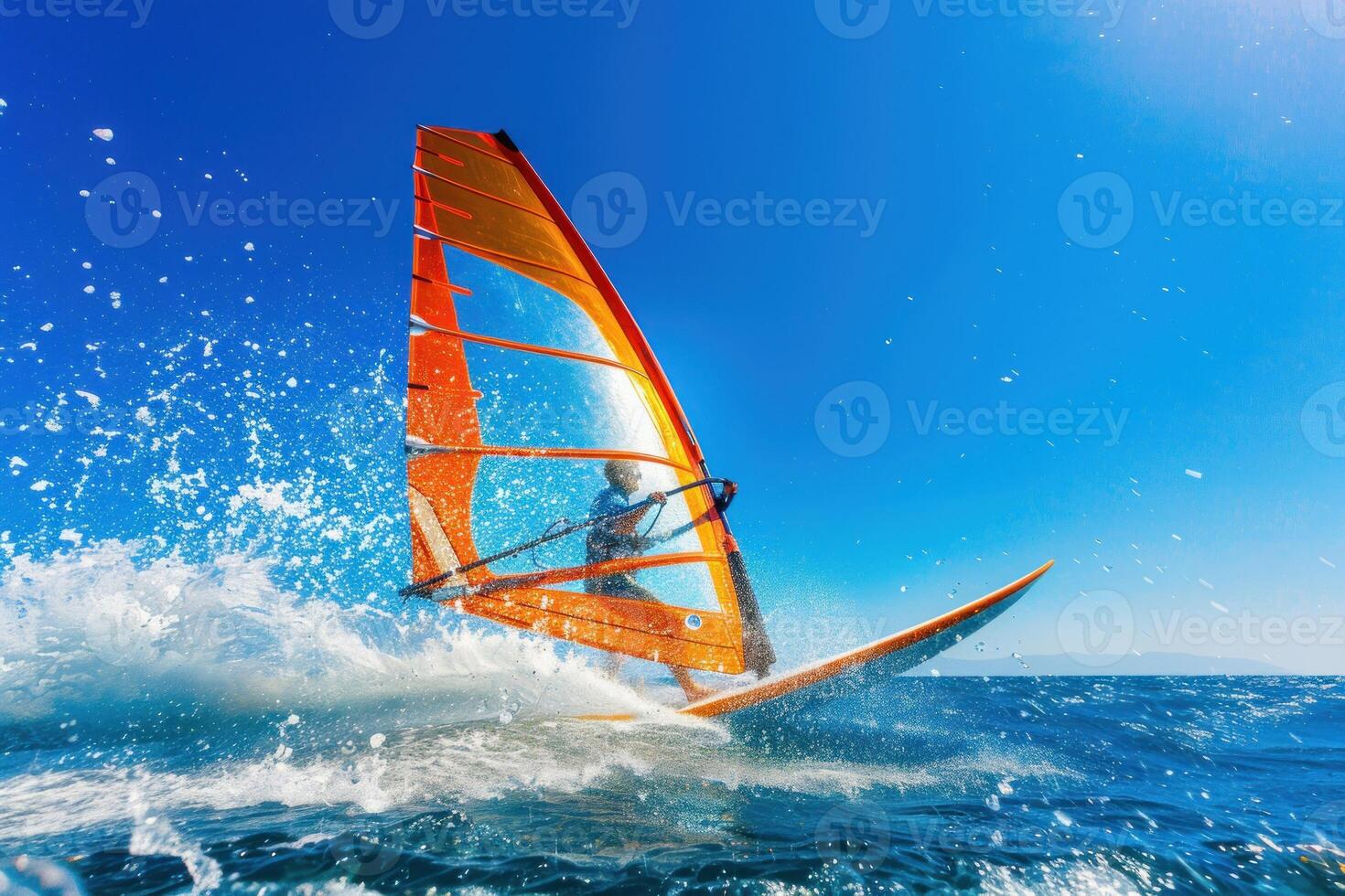 A man windsurfing on a blue ocean photo