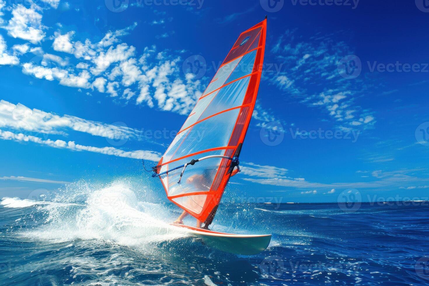 A sailboat with a red and white sail photo