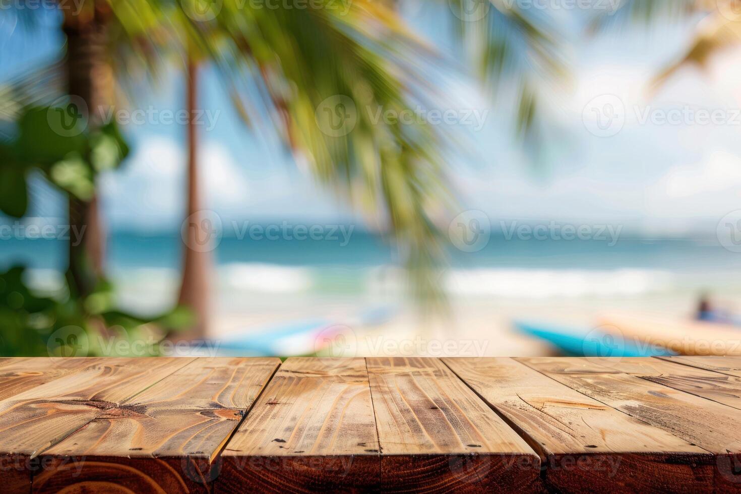 Wooden table top on the beach with palm trees photo