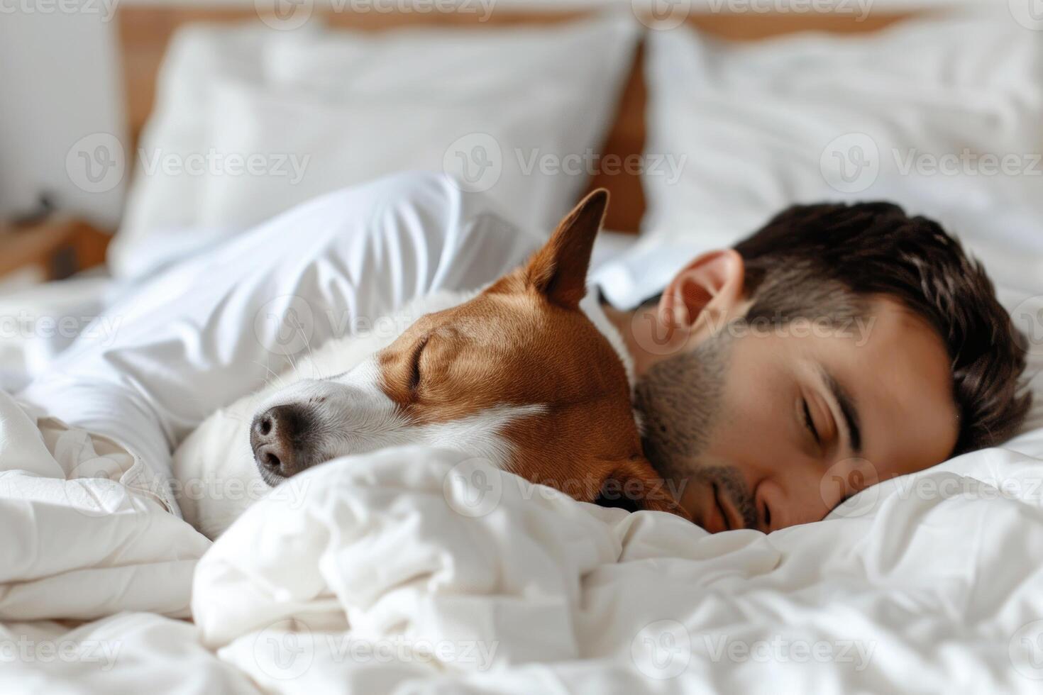 A man sleeping with a dog photo