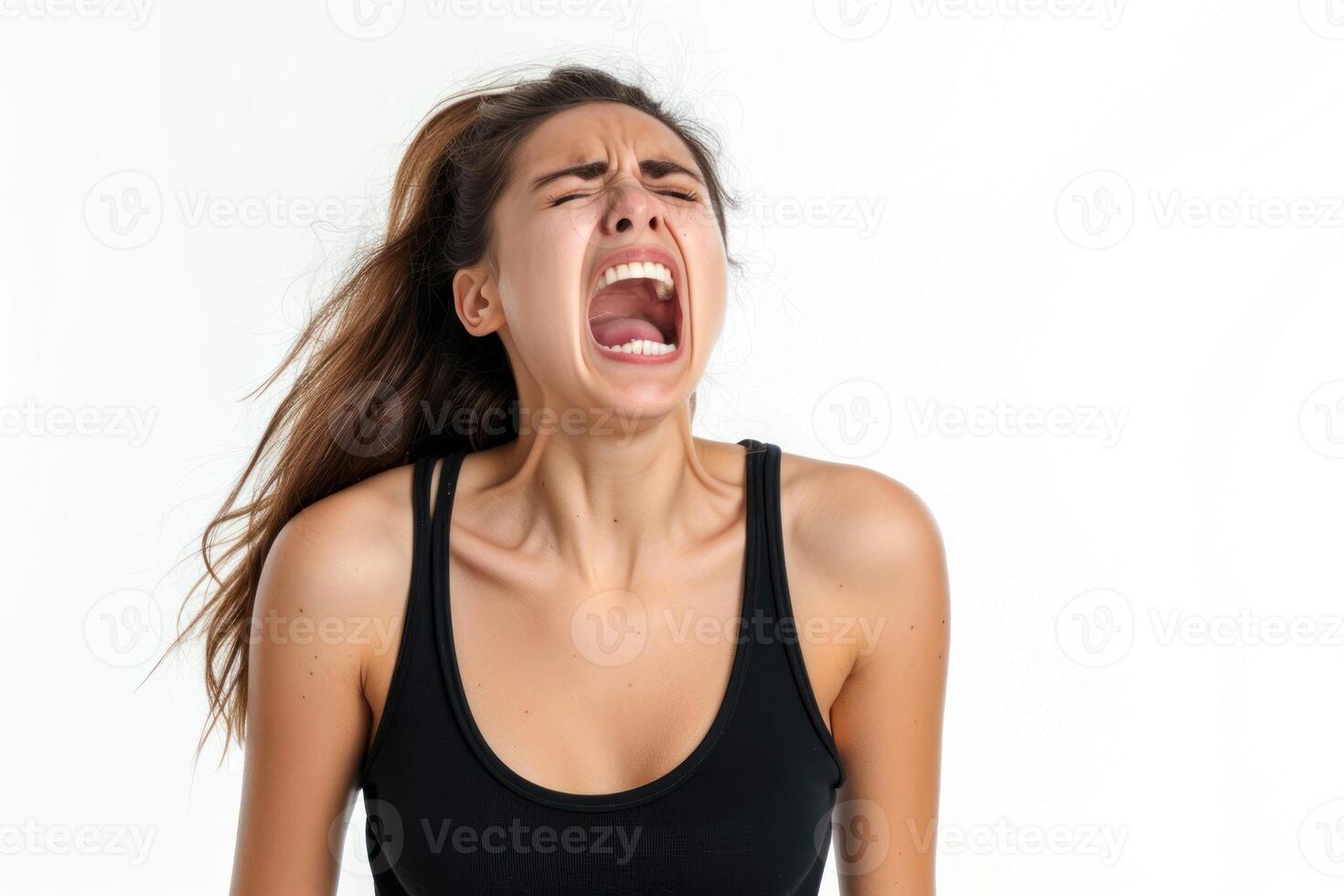 A woman is screaming and holding her mouth open photo