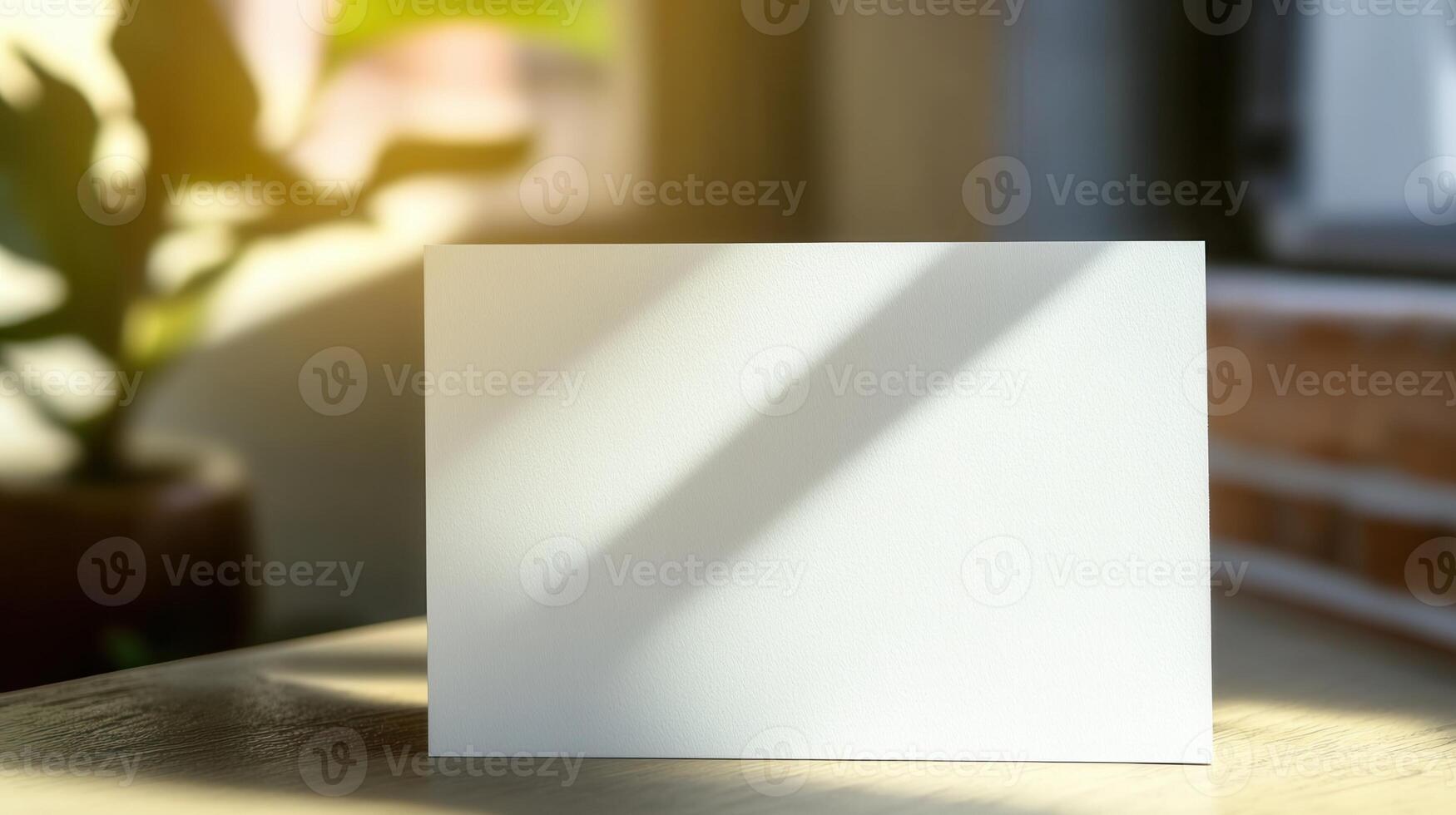 Blank white card on wooden table with sunlight photo