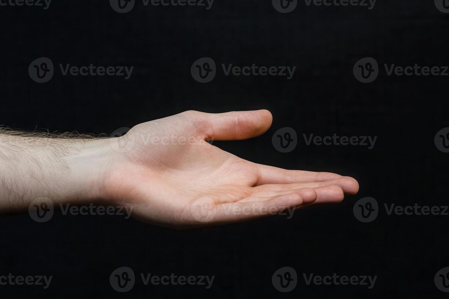 A hand is holding something out to the side photo