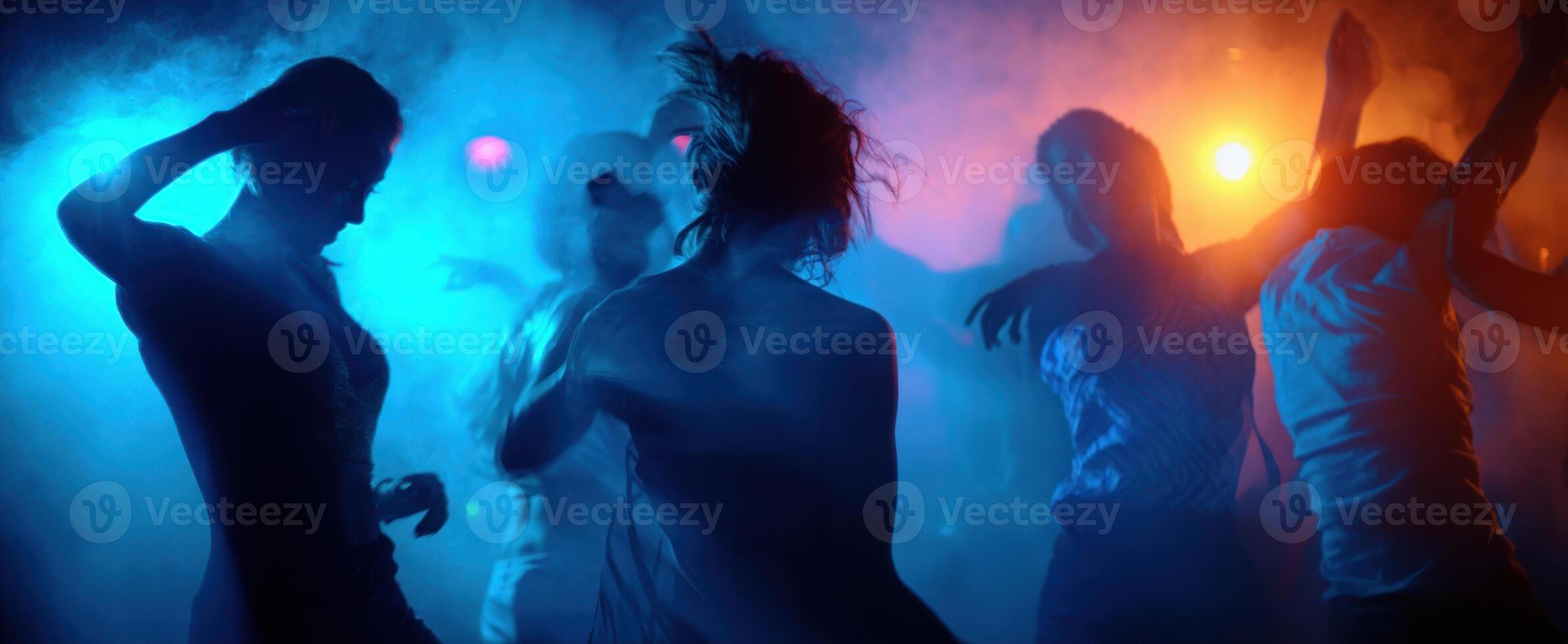 The vibrant dance scene illuminated by colorful lights and energetic movements. photo
