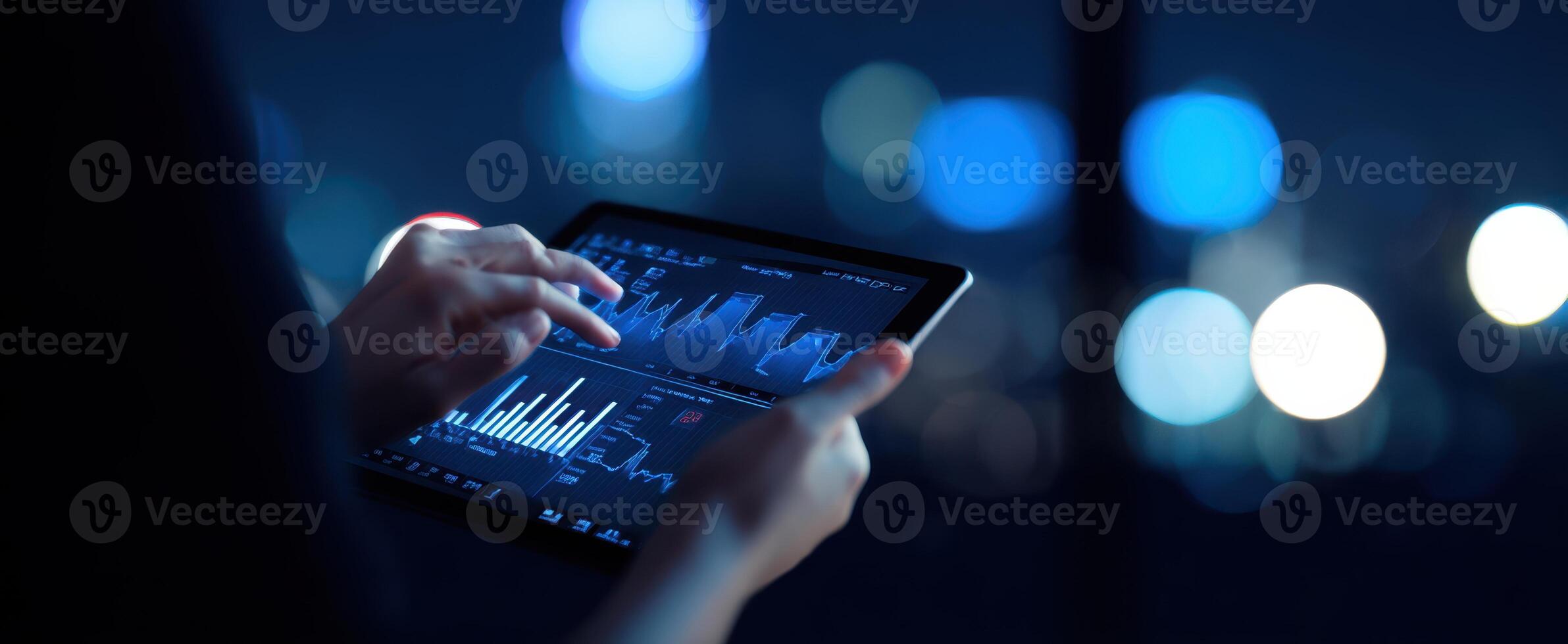 The tablet displaying financial analytics in a modern urban setting at night. photo