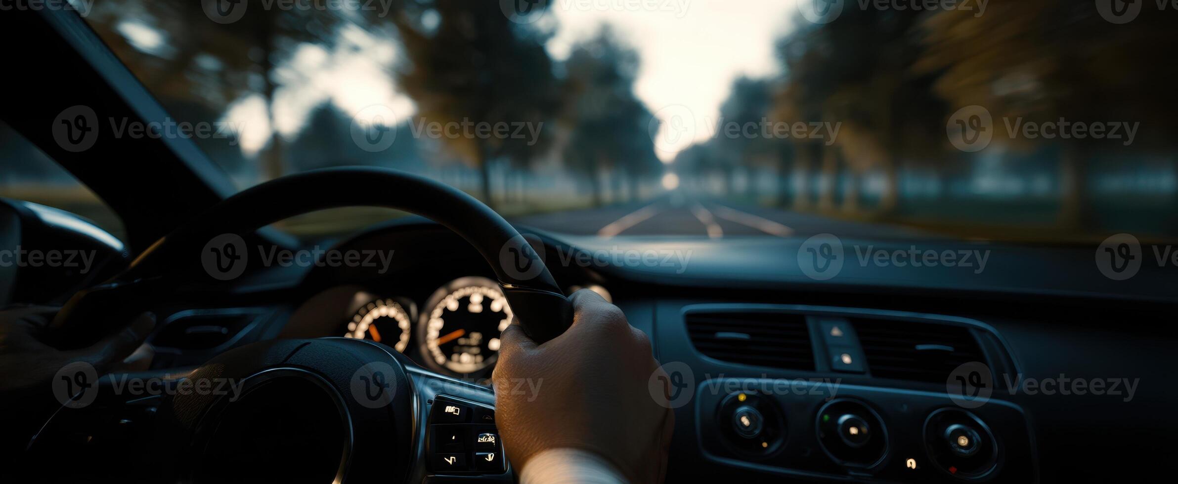 The dynamic experience of driving through a serene, misty landscape. photo