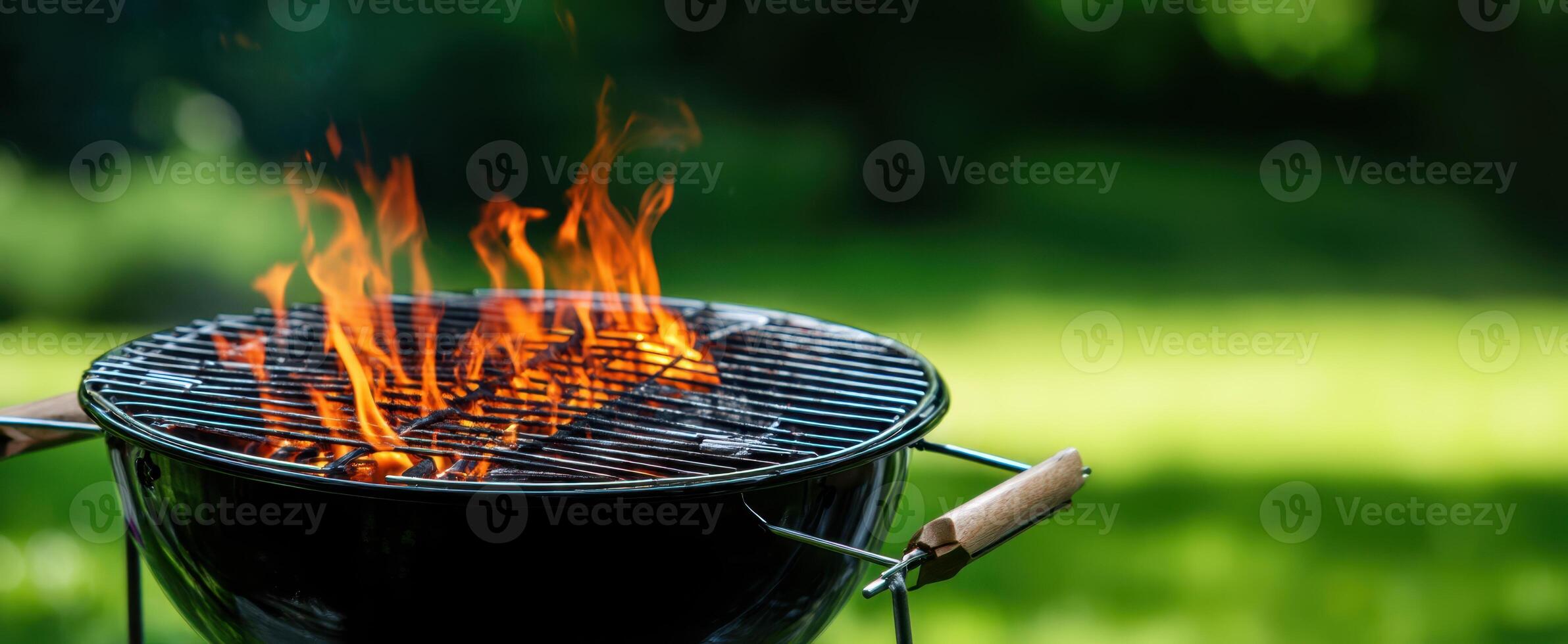 The charcoal grill with vibrant flames ready for summer cooking adventures photo