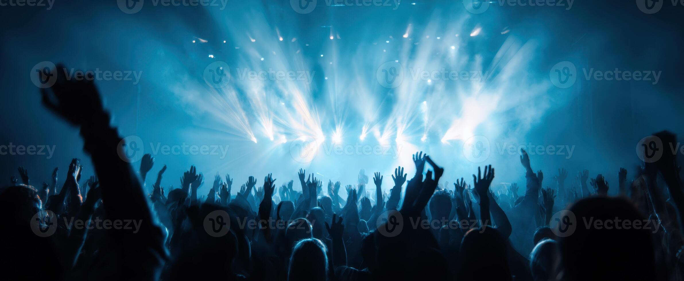 The Enthusiastic Audience Celebrating at a Vibrant Music Concert Event photo