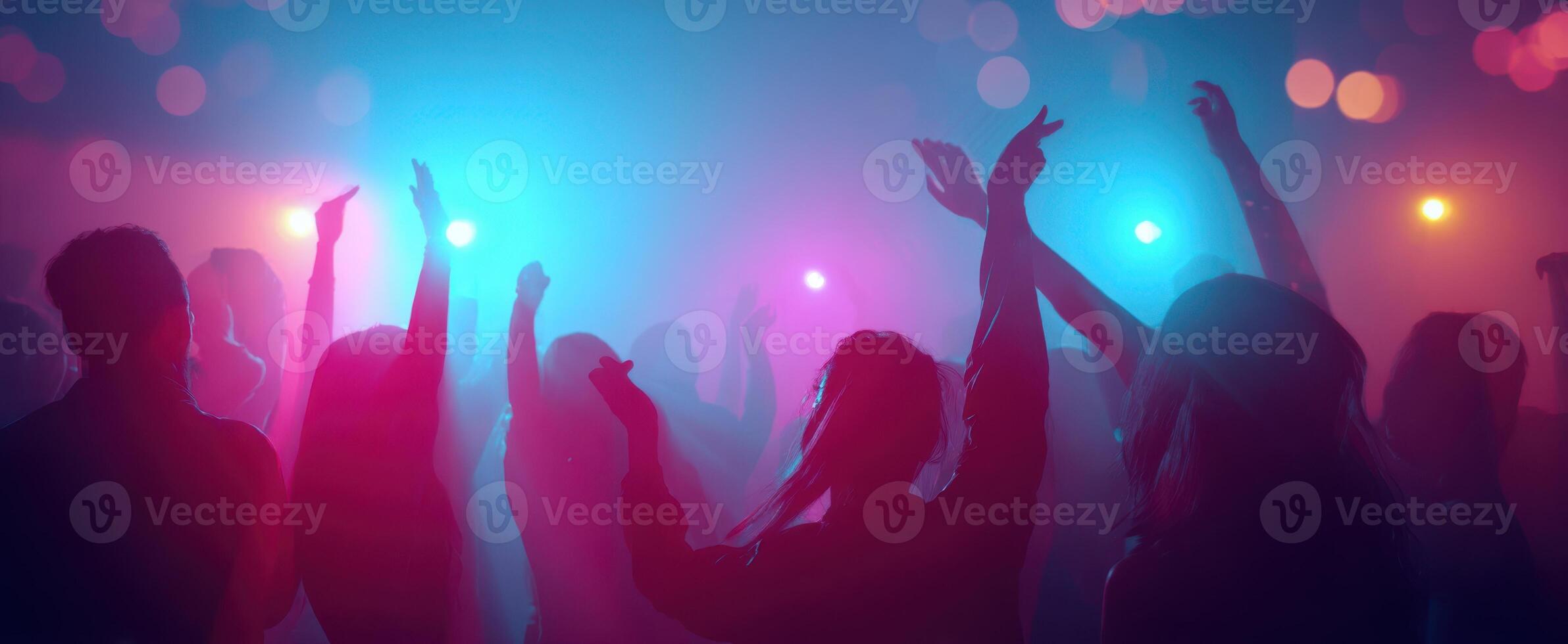 The vibrant dance party scene filled with silhouettes and colorful lights. photo