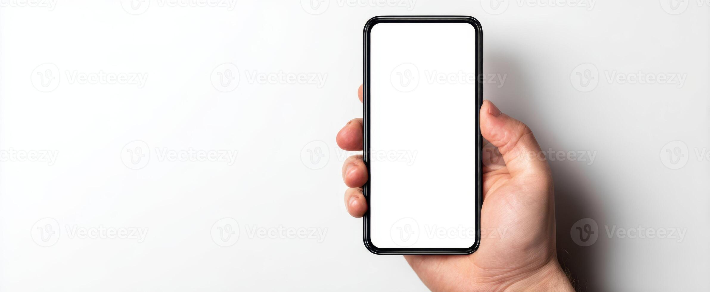 The smartphone held in a hand showcasing a blank screen for mockup purposes. photo