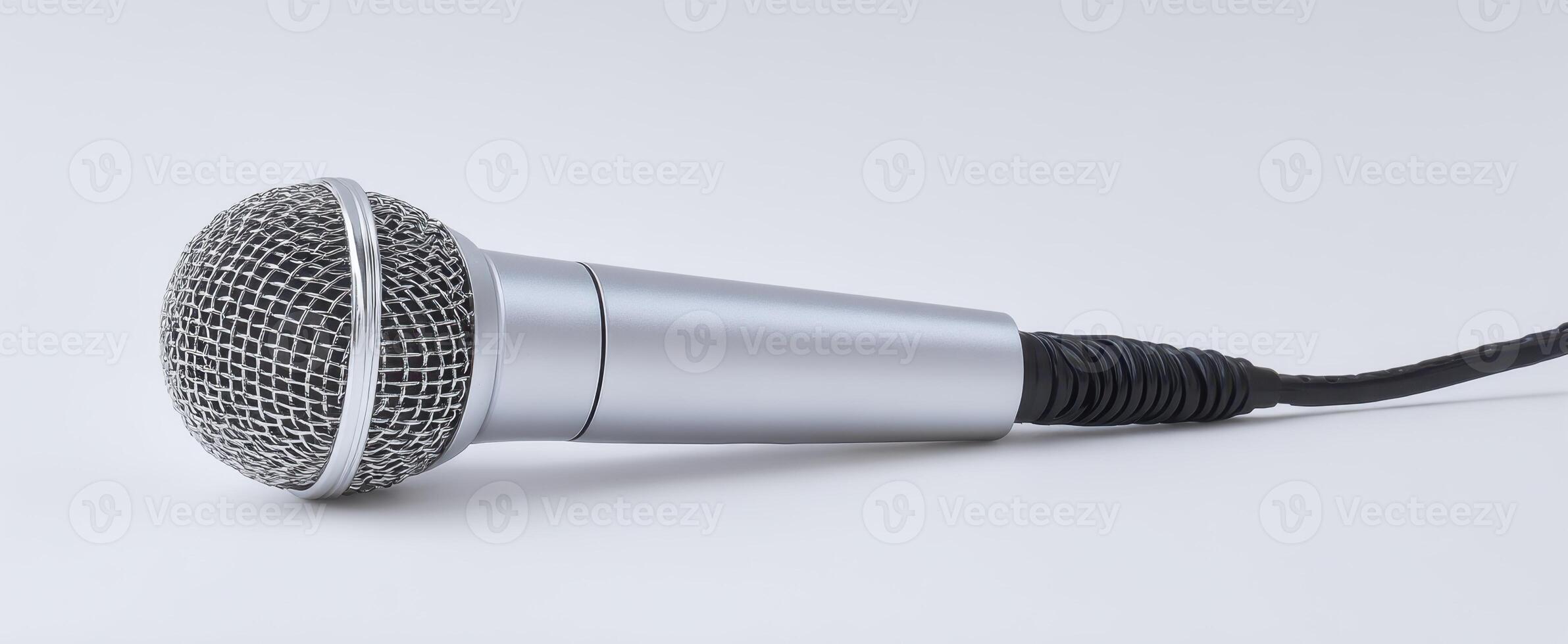The microphone resting on a clean, minimalist surface for audio recording. photo