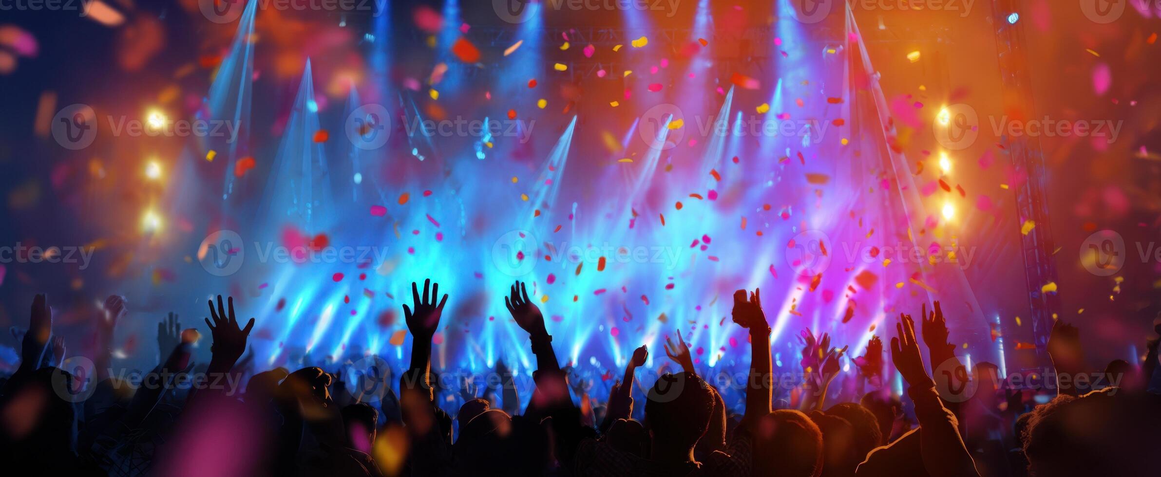 The vibrant concert atmosphere filled with cheering crowds and colorful lights. photo