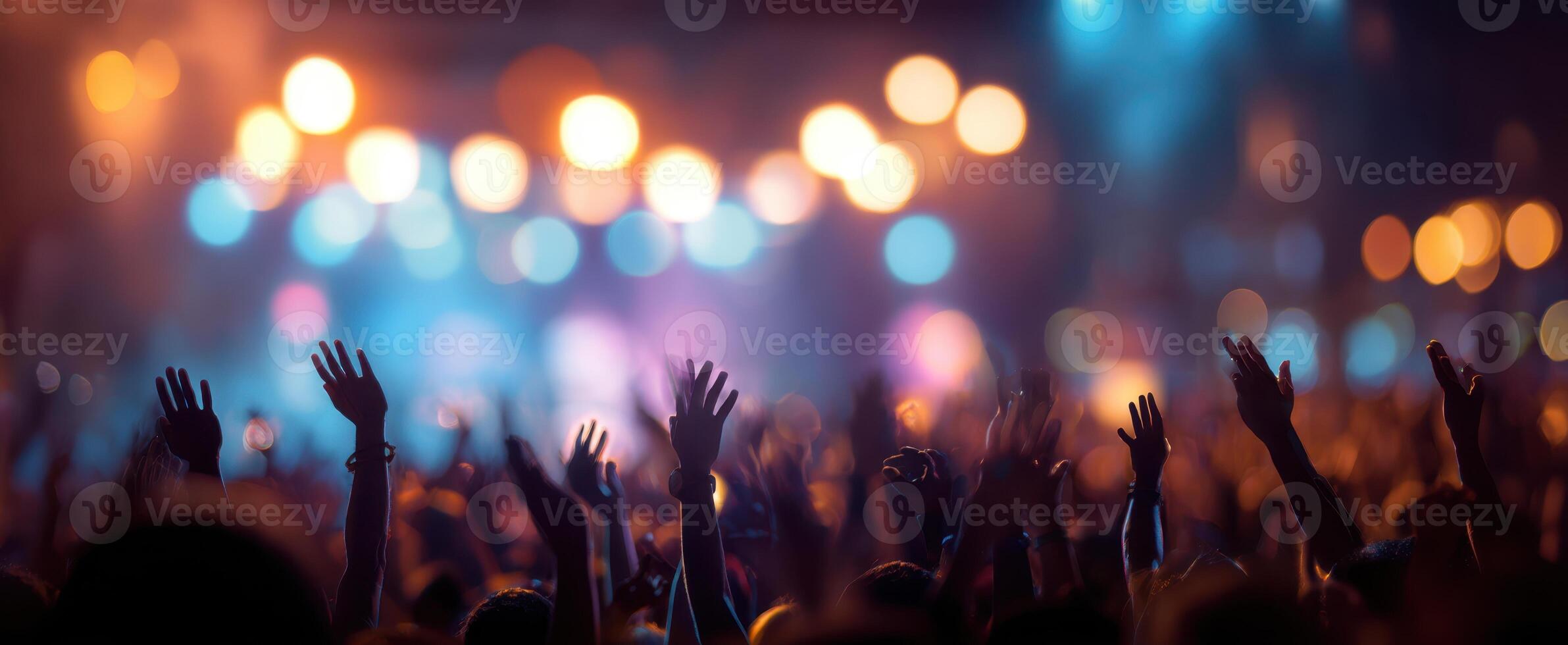 The exhilarating atmosphere of a concert with energetic hands raised high. photo