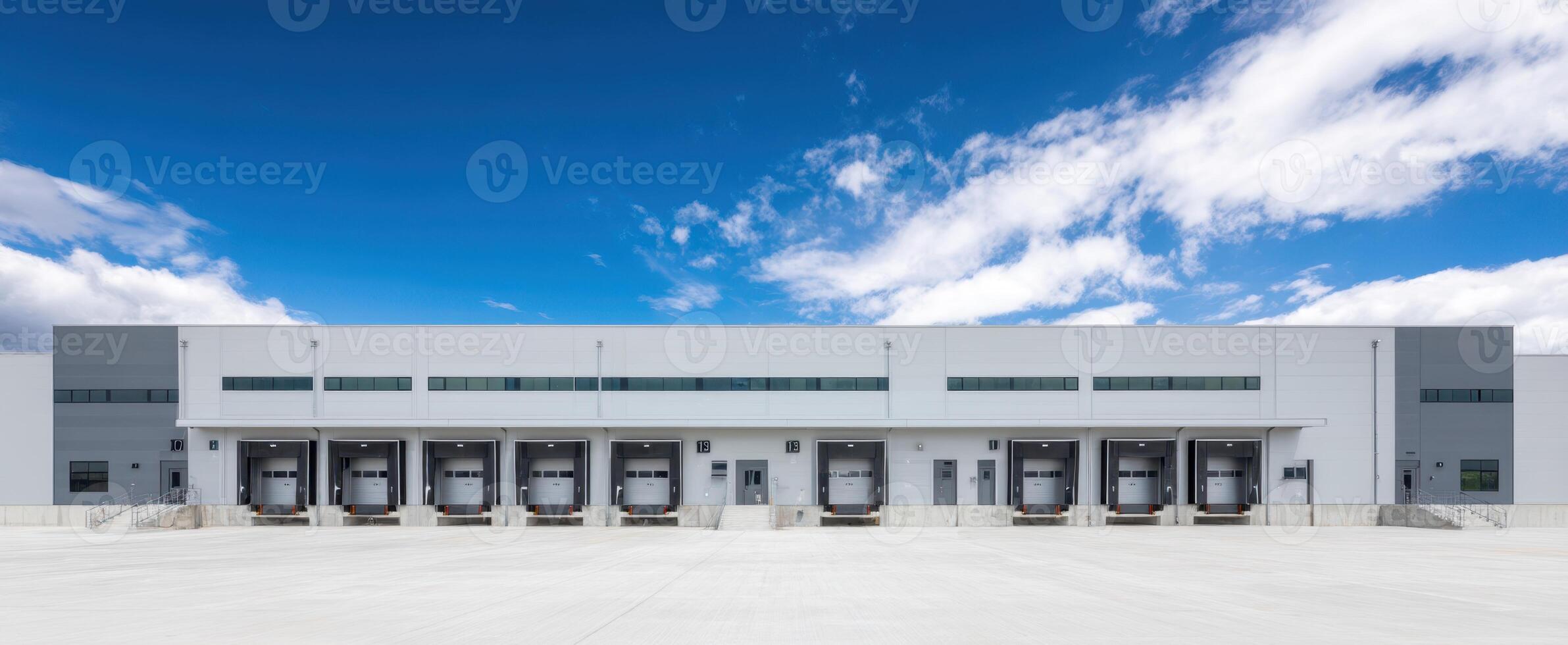 The modern warehouse with loading docks under a bright blue sky. photo