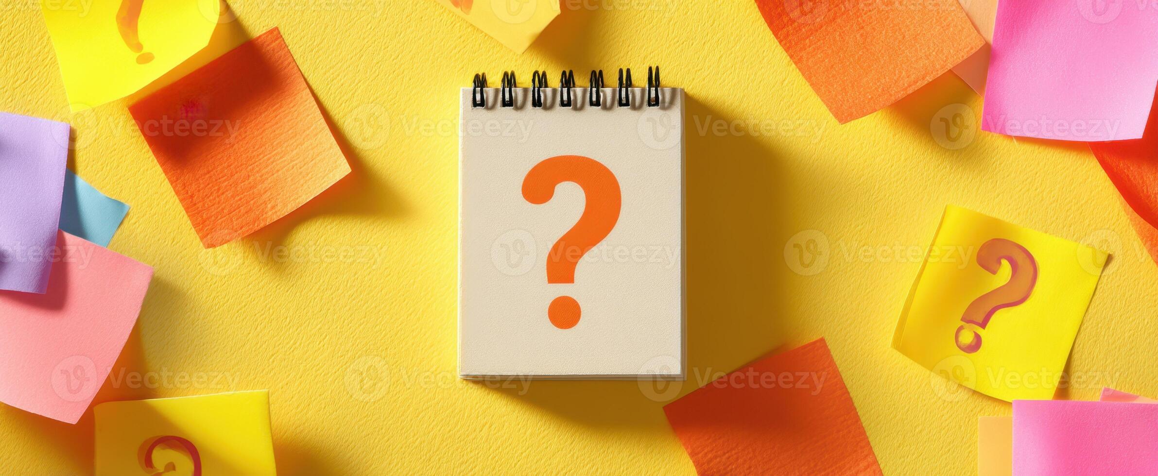 The notebook with a question mark surrounded by colorful sticky notes. photo