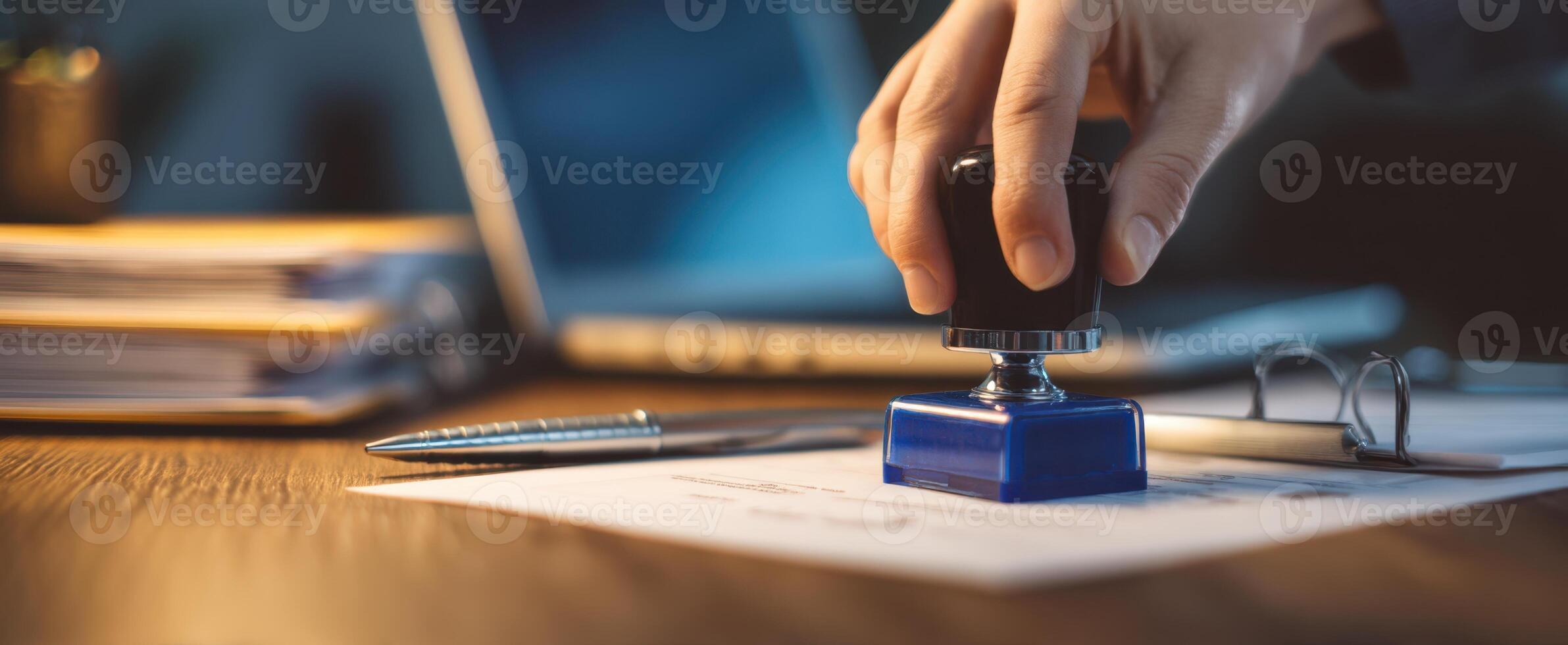 The hand applying a stamp on important business documents for approval. photo