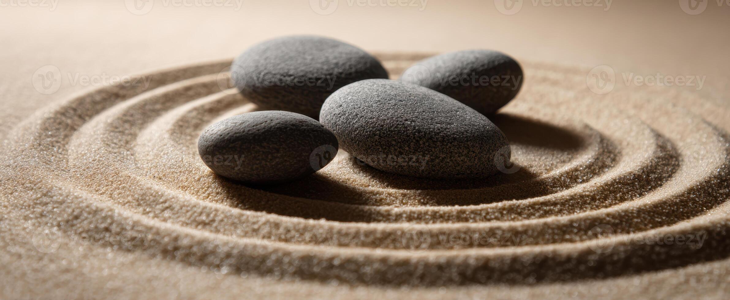 The tranquil stones resting on sand in swirling patterns photo