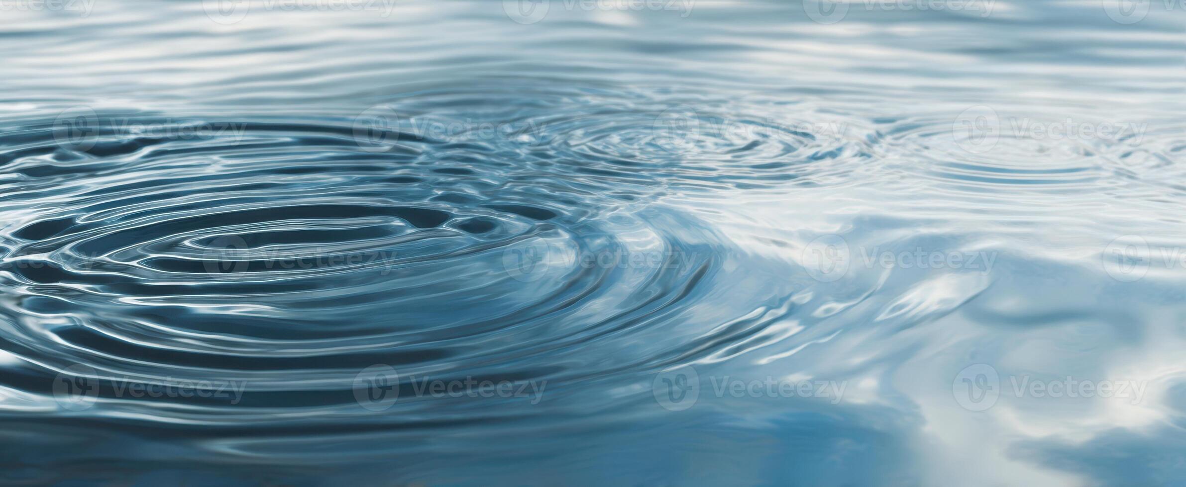 The tranquil water rippling with soft reflections under a serene sky photo