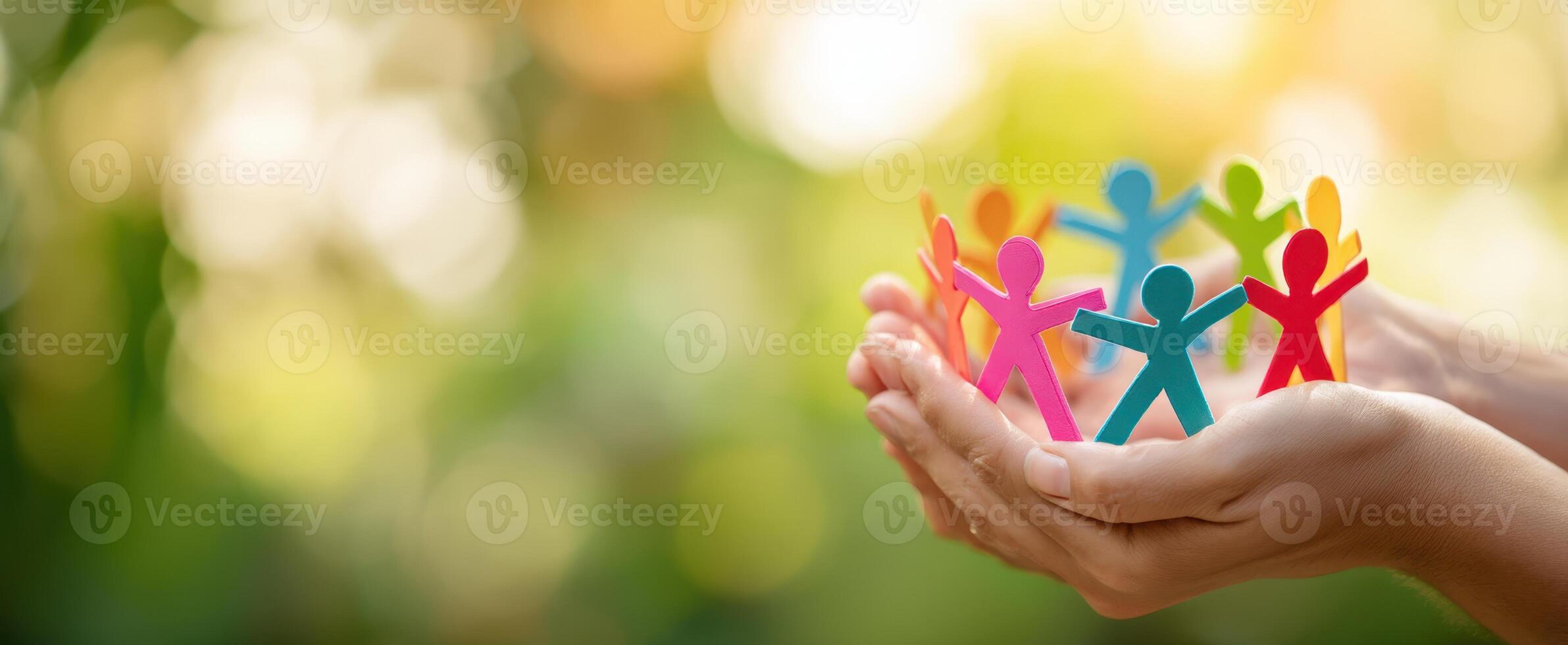 The vibrant paper cutouts representing community and togetherness in supportive hands. photo