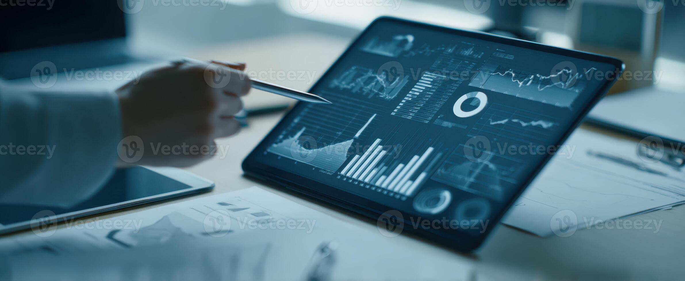 The tablet displaying comprehensive data analytics in a modern office setting. photo