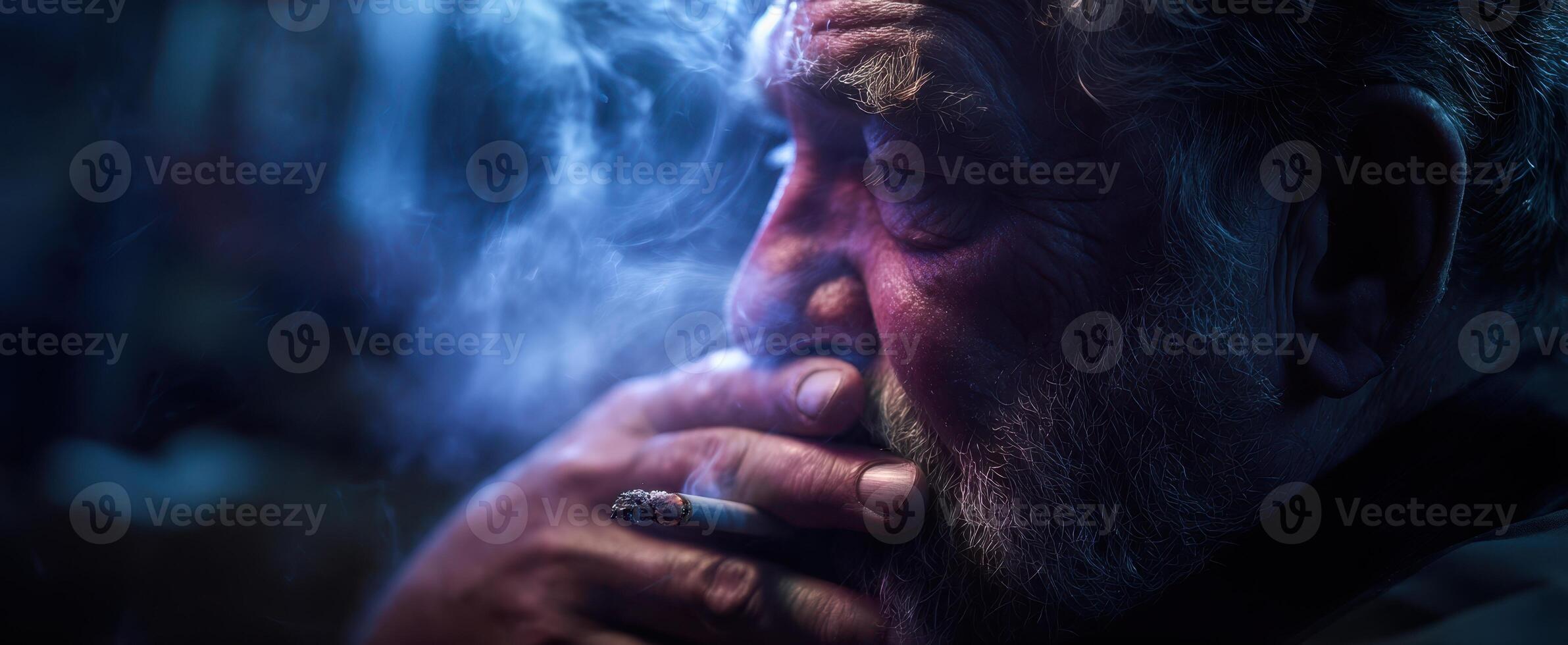 The introspective man enjoying a moment of solitude with a cigarette. photo