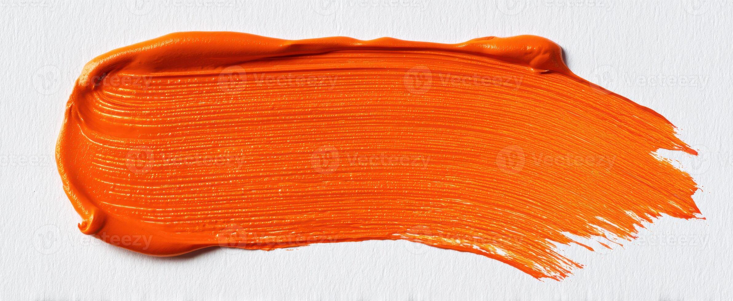 The bright orange paint stroke on a textured canvas backdrop. photo