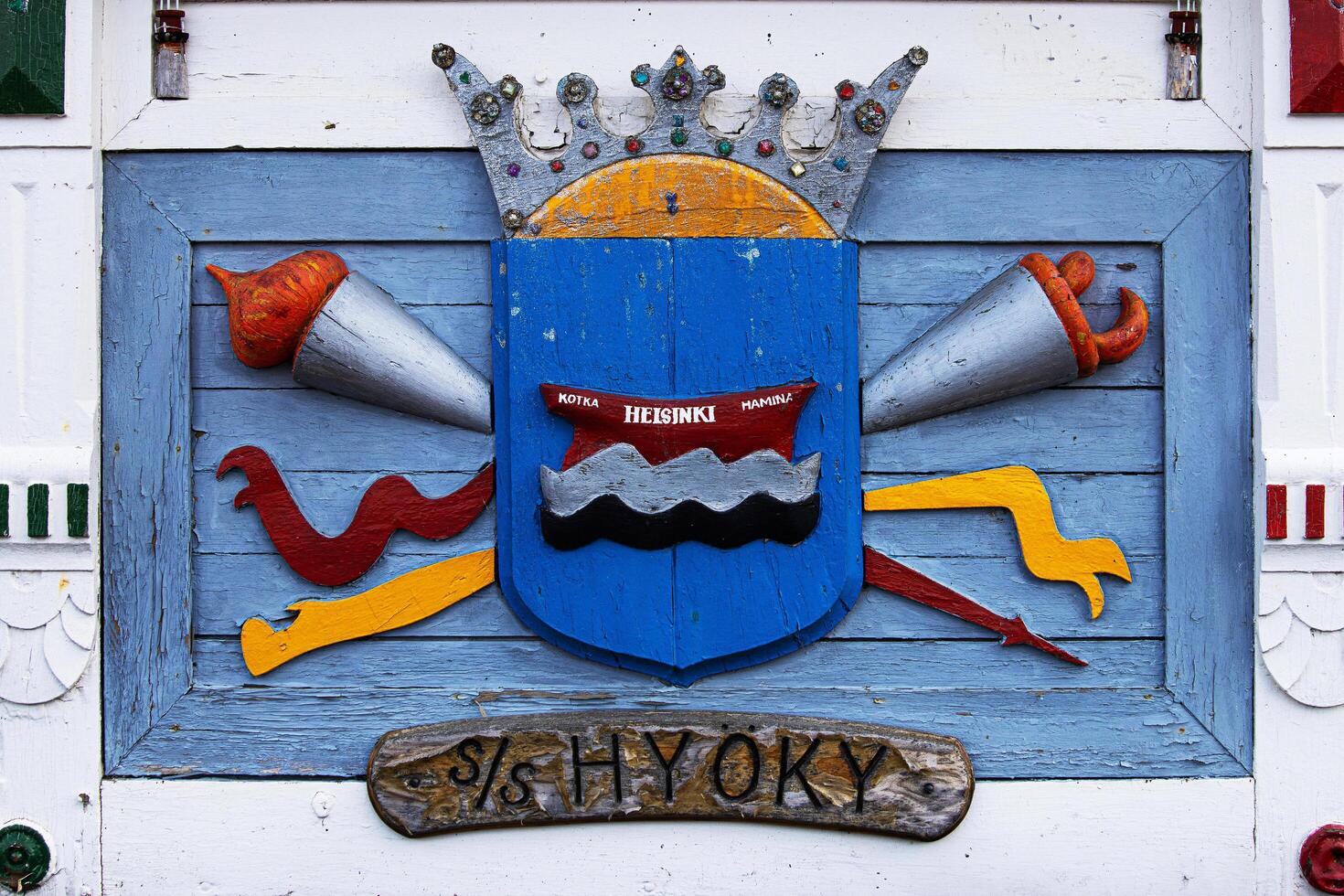 Tervasaari, Hamina, Finland, August 26th, 2023. A handcrafted wooden emblem of steam ship SS Hyoky. The shield includes names of finnish cities Kotka, Helsinki, Hamina. photo