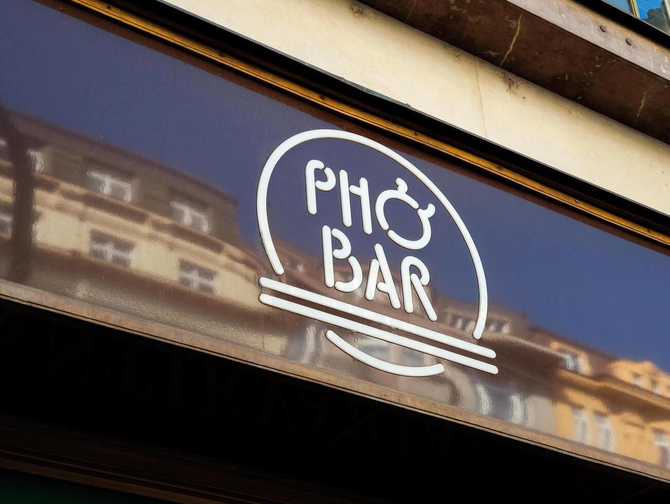 Prague, Czech republic - April 30, 2025. Pho bar sign reflecting prague architecture in czechia photo
