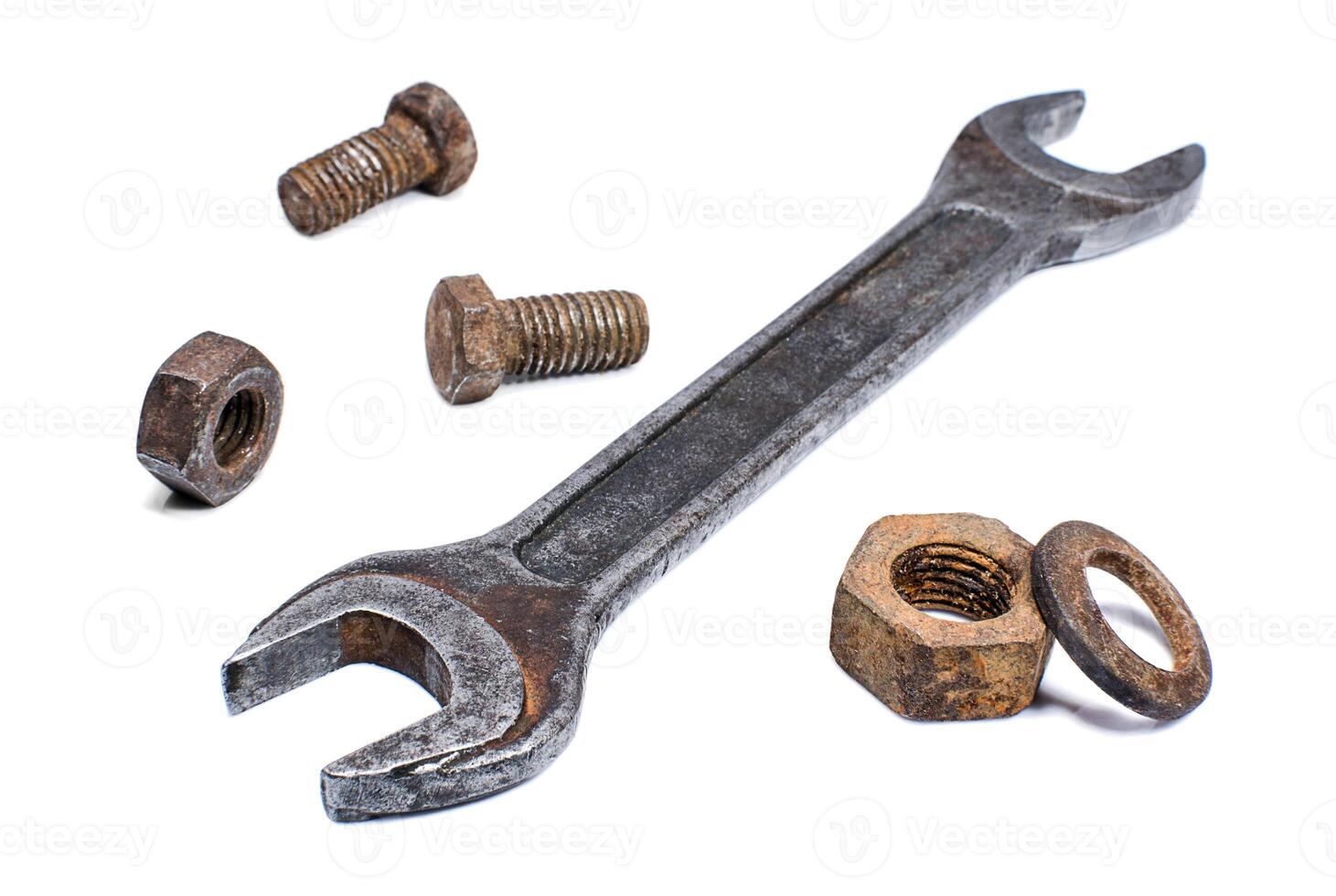 Shabby spanner and rusty nuts, bolts on white background photo