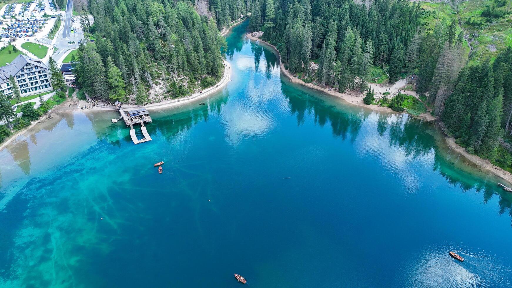 Serene lakeside view with lush forests and tranquil waters during a sunny day in a nature paradise photo