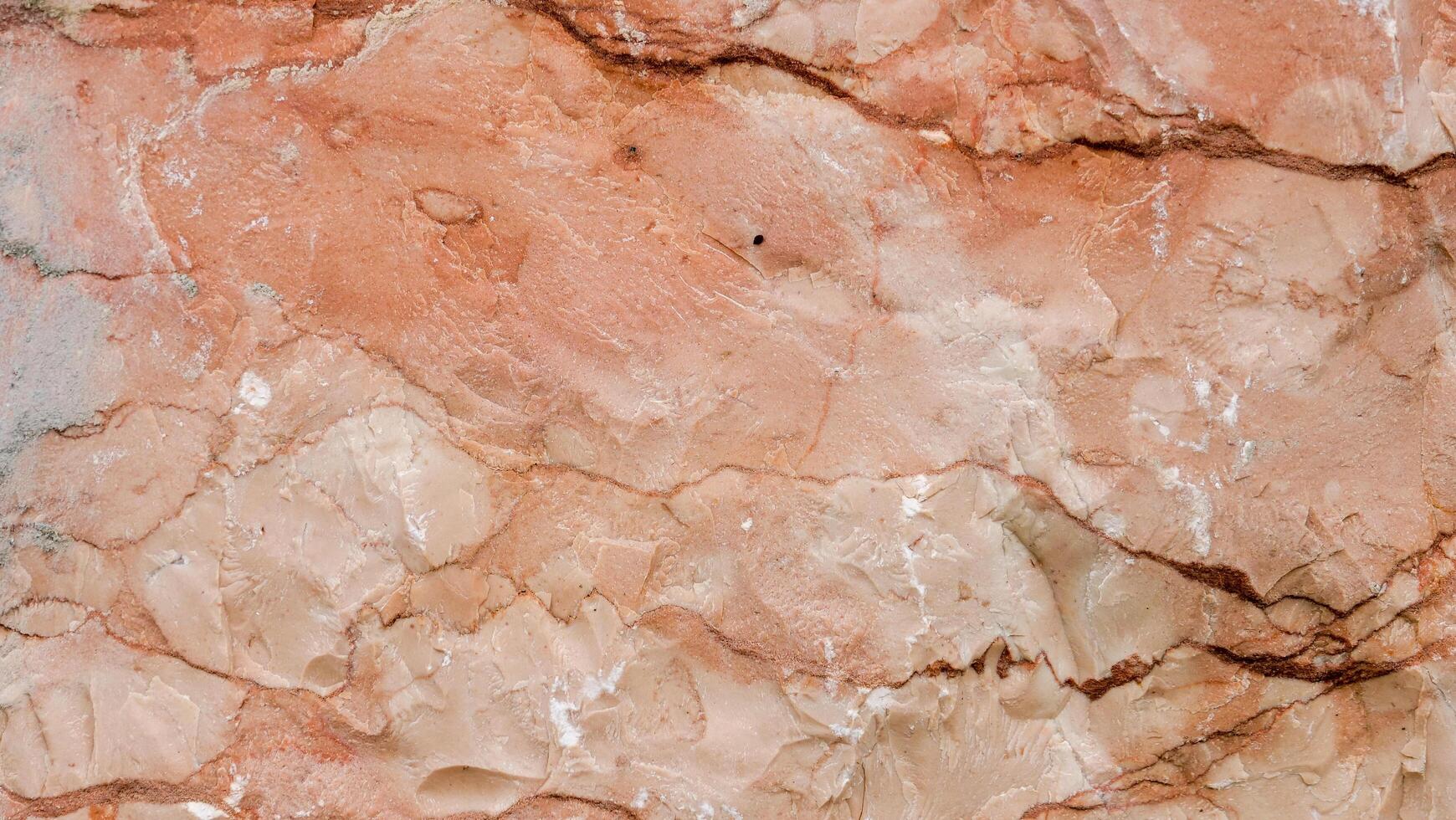 Textured layers of ochre and peach hues create a natural masterpiece on rocky terrain under soft sunlight photo