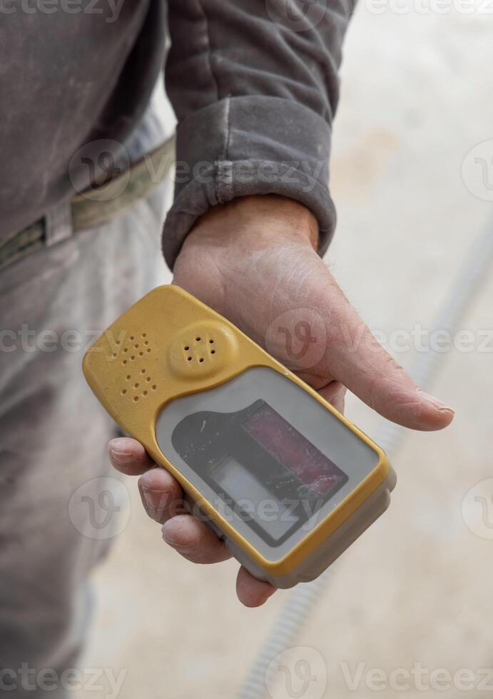 Craftsman hold in dusty hand horizontal rotary laser level device photo