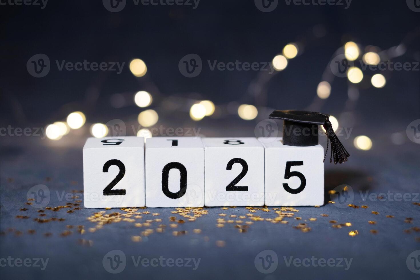 Class of 2025 concept. Wooden cubes with number 2025 with graduate hat photo