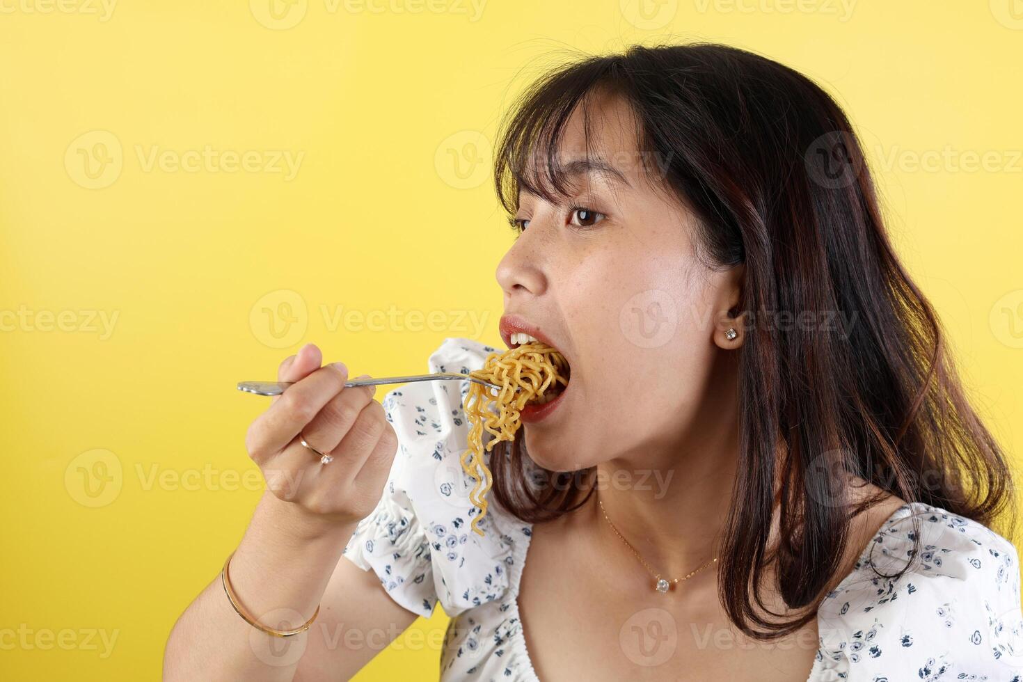 Close Up Excited Young Asian Woman Eating Fried Noodles. photo