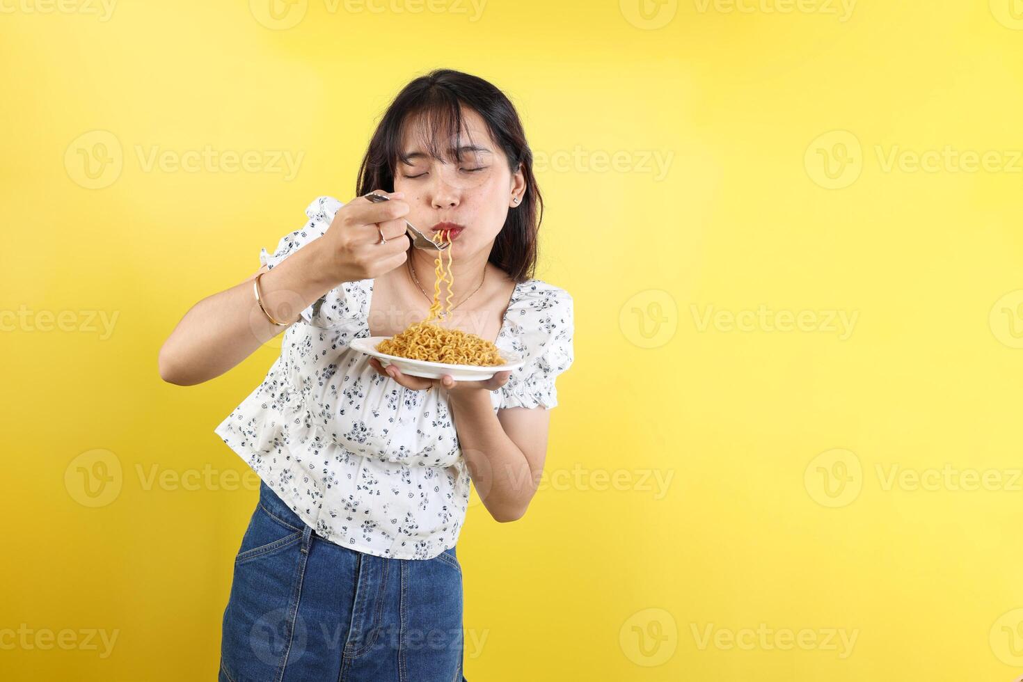 Young Asian Female Eating Delicious Instant Noodle photo