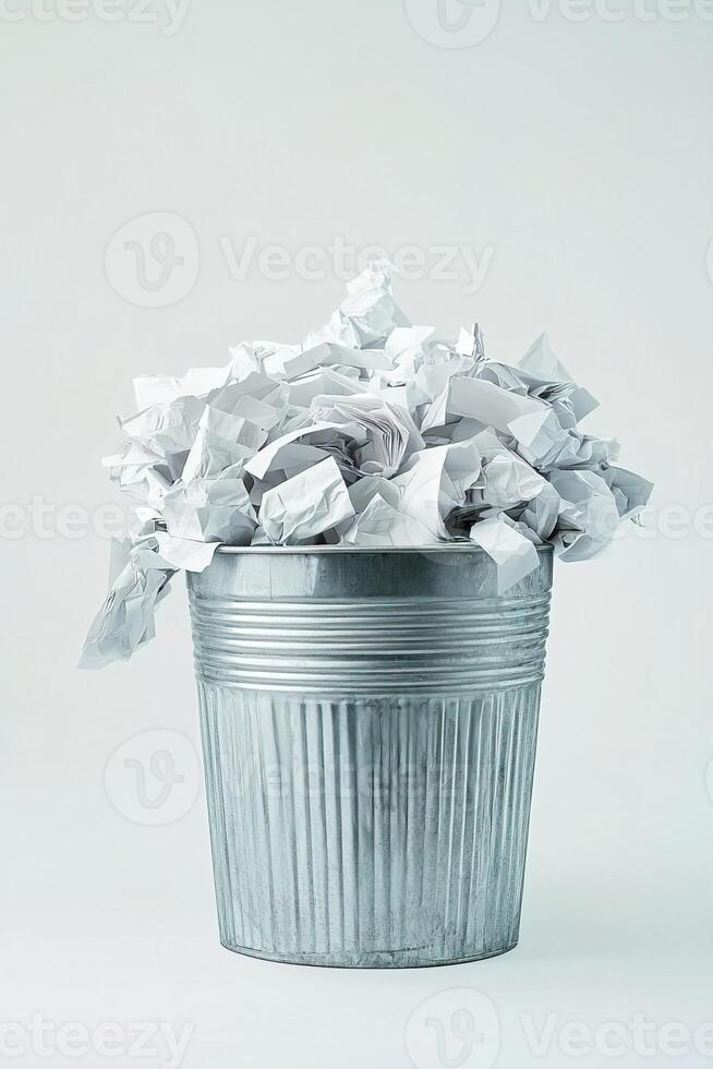 Vertical photo of metal trash can filled with neatly sorted paper waste on clean white background. Ideal for illustrating home waste sorting, eco-friendly lifestyles and sustainable habits