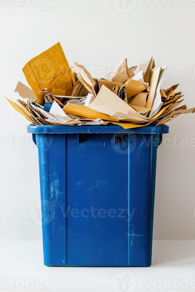 vertical photo blue recycling container filled with paper waste on white background. Use for environmental presentations, social media posts and educational resources
