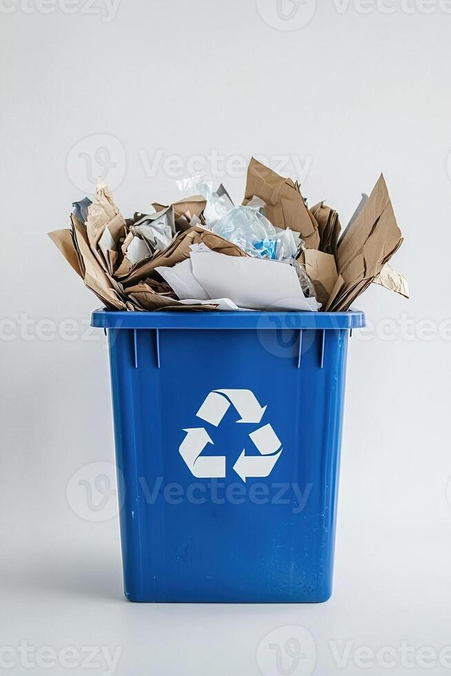 Minimalistic vertical image paper waste in blue recycling bin on clean white backdrop. Perfect for illustrating eco-friendly habits, office recycling systems and sustainability topics photo