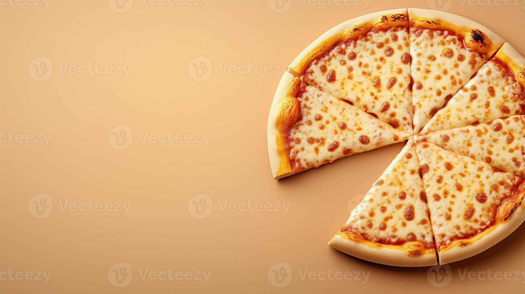Sliced pizza with melted cheese on orange background, with copy space photo