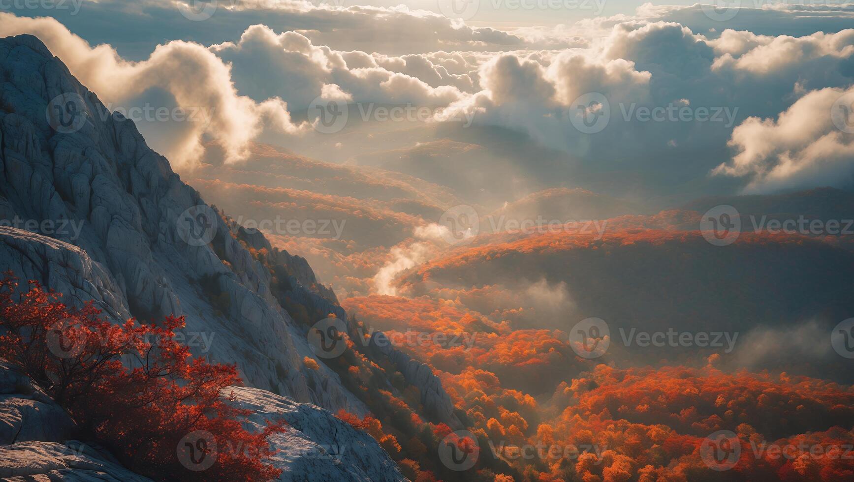 Mountain Peak Overlooking Autumn Forest with Clouds and Sunlight photo