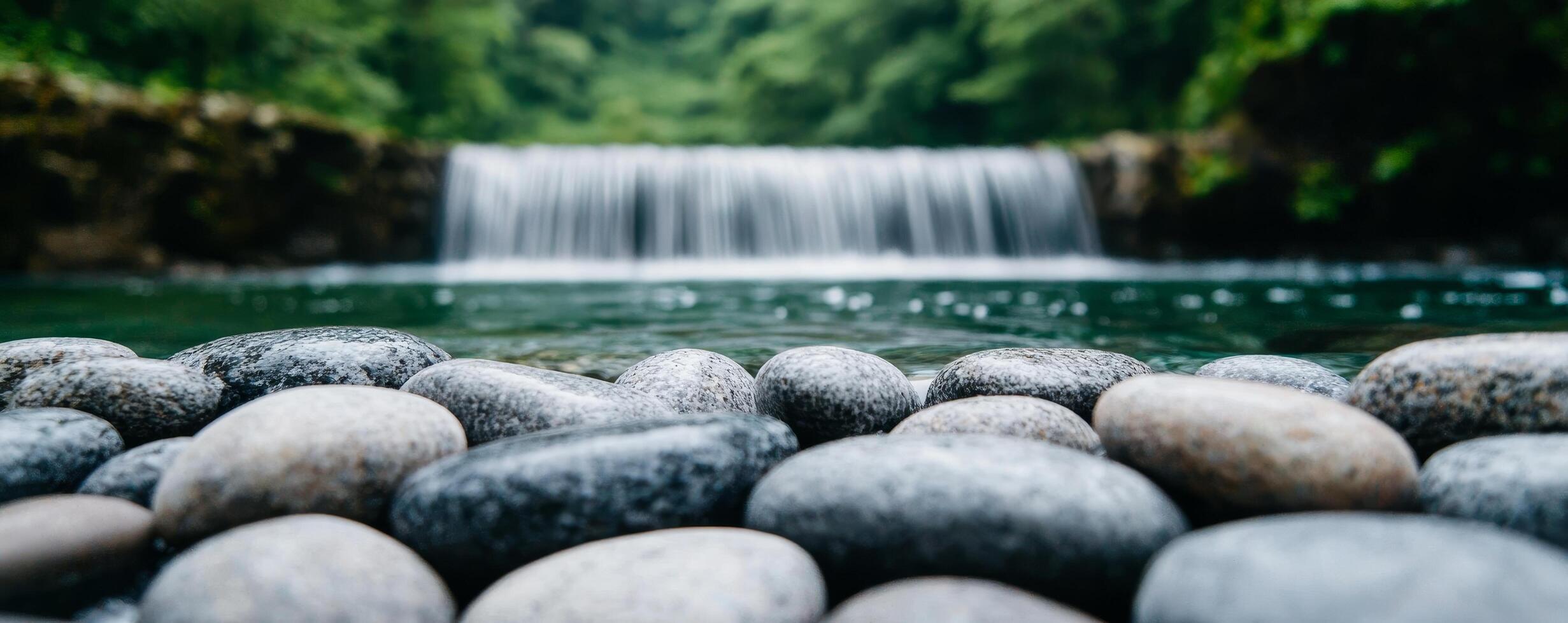 Serene, pure crystal water from gentle rain. Serene waterfall cascading over smooth stones in tranquil nature setting. photo