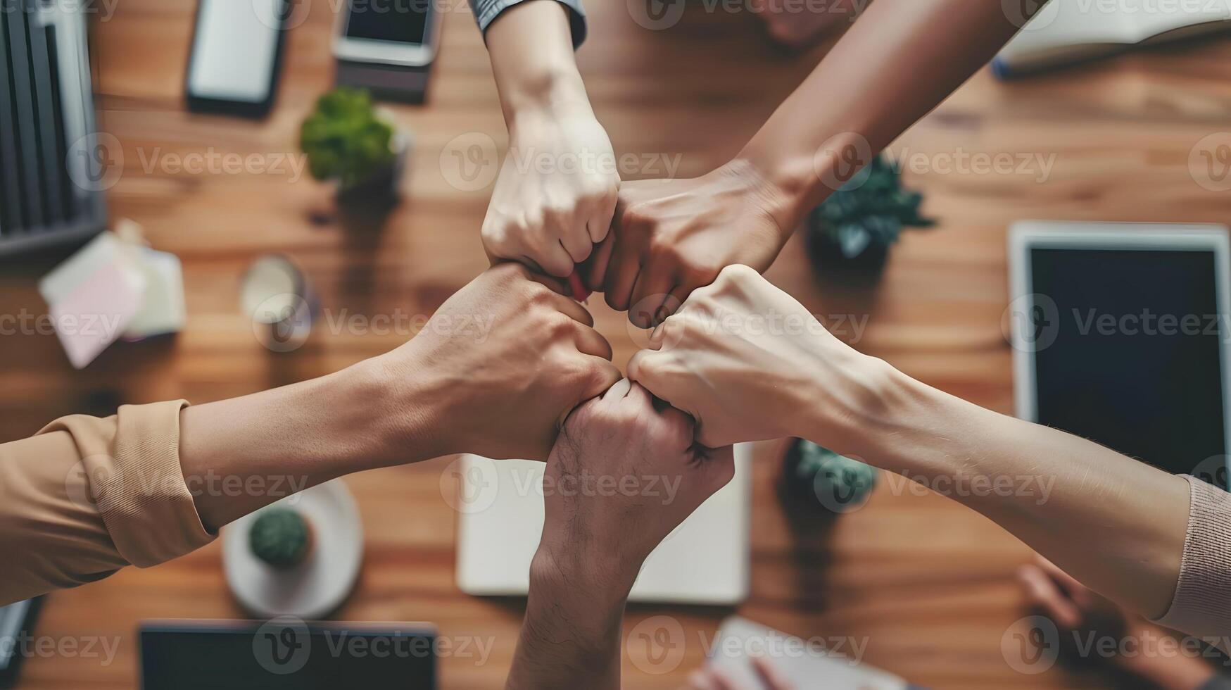 Team celebrating success with fist bump in a modern office environment energetic mood photo