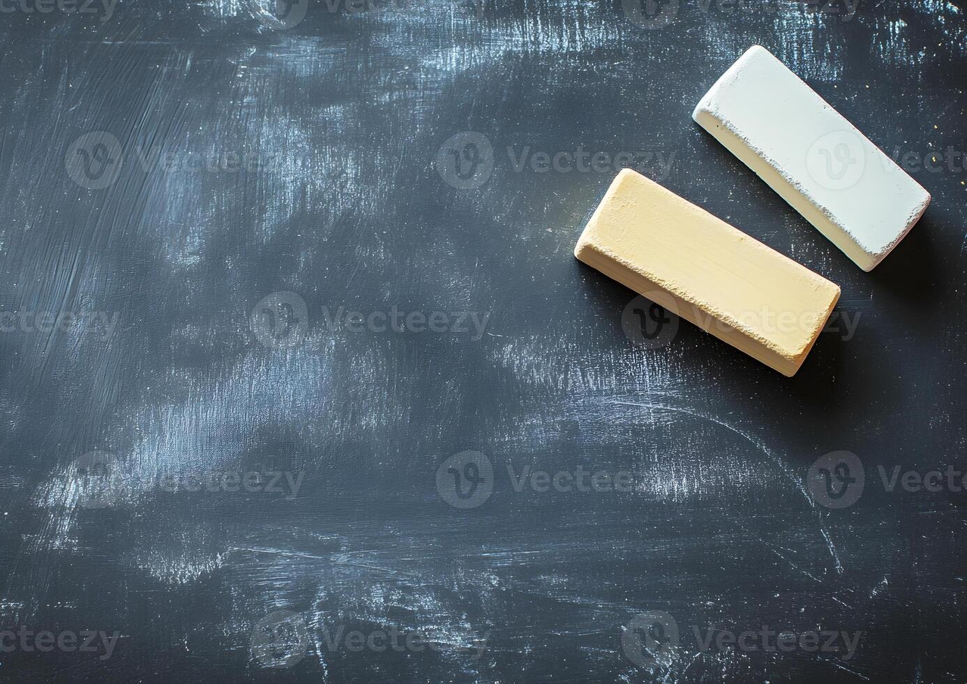 centered chalk and eraser on dark background with balanced spacing photo